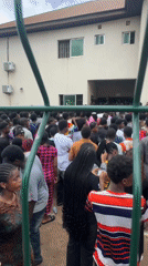 Dense crowd outside institutional building in Ihiagwa, Nigeria
