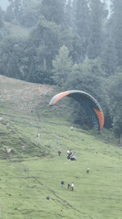Paragliding and mountain views on a clear afternoon in Solang Valley