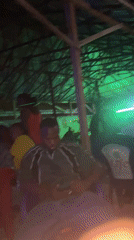 People gather in lit interior space in Wukari, Nigeria