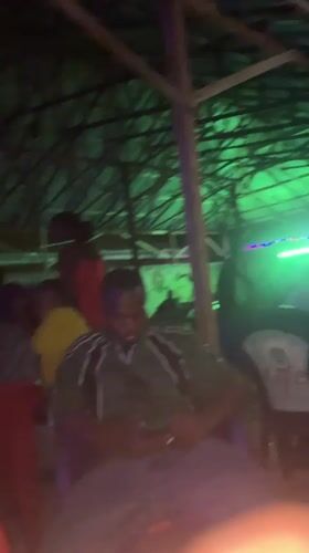 People gather in lit interior space in Wukari, Nigeria
