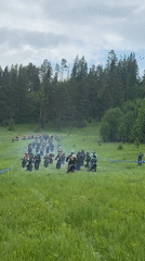 Dirt bikers traverse field near Усть-Сыны, Russia