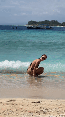 Tattooed woman enjoys early morning beach time in Indonesia