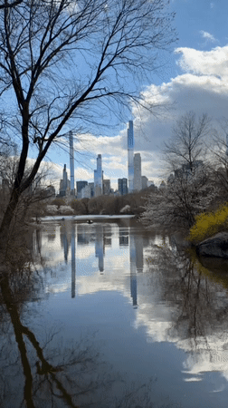 Person walks through stone archway in New York park
