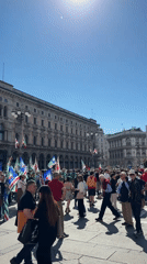 Flag-waving gathering with drummers draws crowds in Milan square