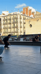Skate tricks at a Barcelona plaza, late afternoon session