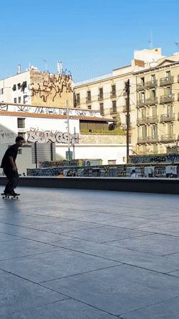 Skate tricks at a Barcelona plaza, late afternoon session