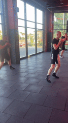 Boxing training session in a neon-lit gym