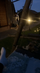 Person dances with dog in Belarus backyard at dusk