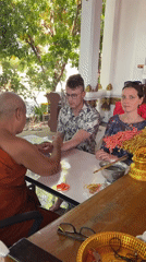 Buddhist monk blesses tourists at Thai temple