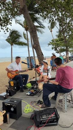 Street Musicians Perform on Pattaya Beach Promenade Under Overcast Skies