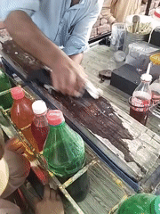 Street vendor serves shaved ice treats to children in Pakistan