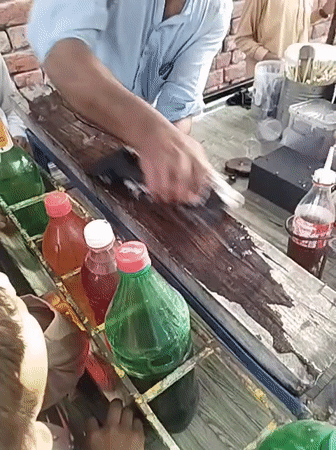 Street vendor serves shaved ice treats to children in Pakistan