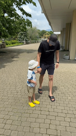 Man and child walk together on path in Nebug