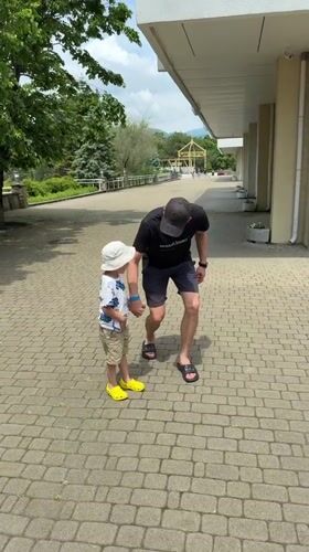 Man and child walk together on path in Nebug