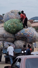 Street vendors and haulers at work in a busy urban market