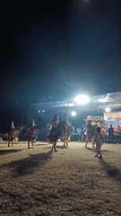 Traditional costumed dance performance with live gamelan, outdoors at night