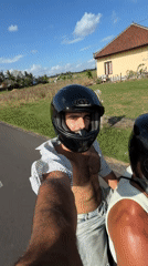 Scooter passengers film ride through Indonesian countryside