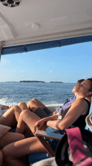 Tourists relax on boat journey near Maafushi, Maldives