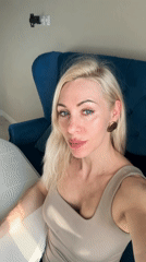 Woman enjoys wine and poses for photos on blue sofa