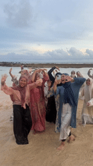 Hijab-wearing women take group beach selfie in South Kuta