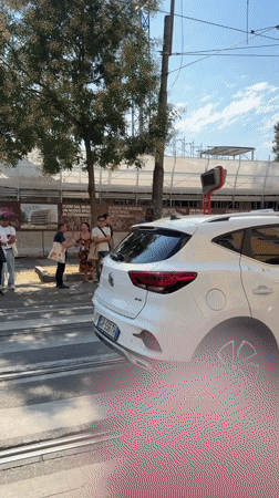 Milan morning: tram stop street scene and a salon selfie