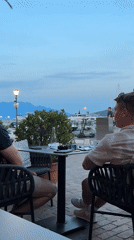 Evening dining scene captured at Montenegro harbor restaurant patio