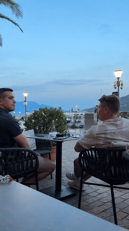 Evening dining scene captured at Montenegro harbor restaurant patio