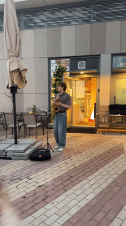 Saxophone on the patio, park paths at dusk, Moscow evening
