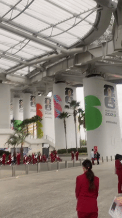 Red-suited group assembles at modern Inglewood stadium entrance