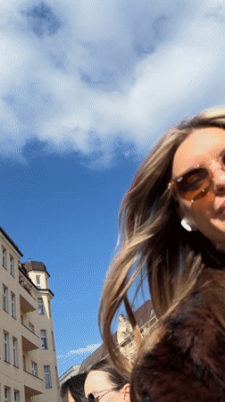 Woman takes multiple selfies on Berlin street