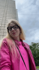 Woman in pink jacket filmed, photographed outdoors in Izhevsk