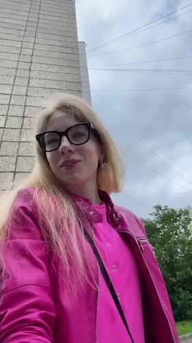 Woman in pink jacket filmed, photographed outdoors in Izhevsk