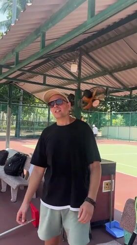 Tennis morning at a Nha Trang court with surrounding street scenes