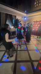 Women dance under disco lights in Monchegorsk room