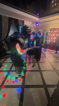 Women dance under disco lights in Monchegorsk room