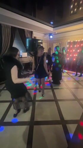 Women dance under disco lights in Monchegorsk room