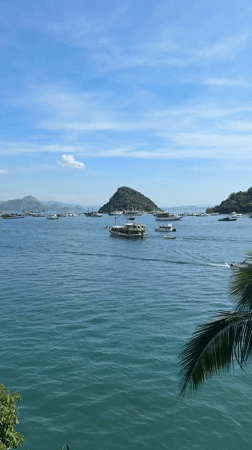 Boats anchored in calm Labuan Bajo harbor waters