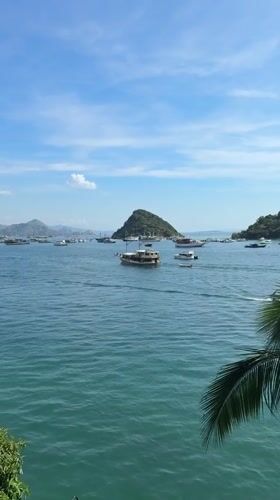 Boats anchored in calm Labuan Bajo harbor waters