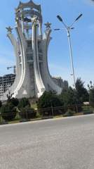 White monument with gold stars documented in Khujand, Tajikistan