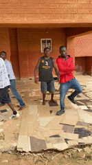 Four men gather at covered outdoor space in Vom