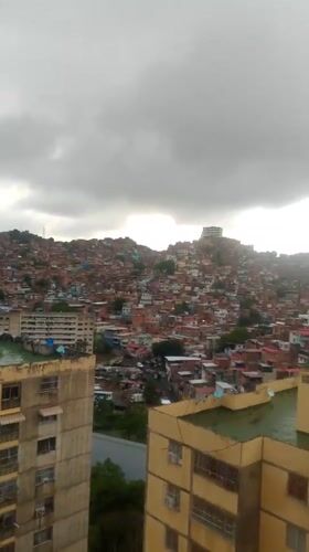 Evening documentation captures Caracas barrios during heavy rainfall