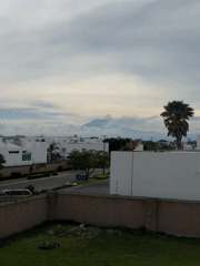 Volcano looms over modern housing in Tlaxcalancingo, Mexico