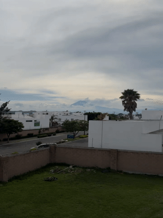 Volcano looms over modern housing in Tlaxcalancingo, Mexico