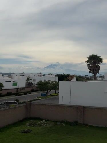 Volcano looms over modern housing in Tlaxcalancingo, Mexico