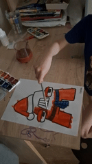 Child paints cartoon character at desk in Saint Petersburg