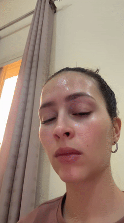 Woman uses blue light facial device in Abu Dhabi