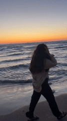 Woman encounters jellyfish during sunset beach walk in Kiryat Yam