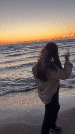 Woman encounters jellyfish during sunset beach walk in Kiryat Yam