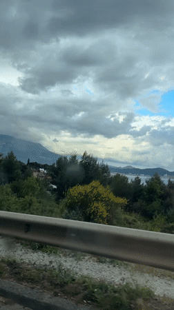 Traveler documents coastal road scenery in Sutomore, Montenegro