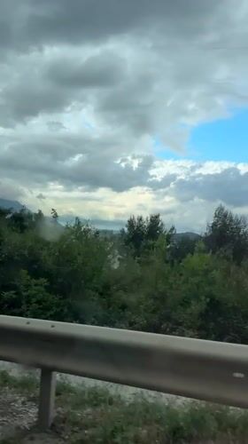 Traveler documents coastal road scenery in Sutomore, Montenegro